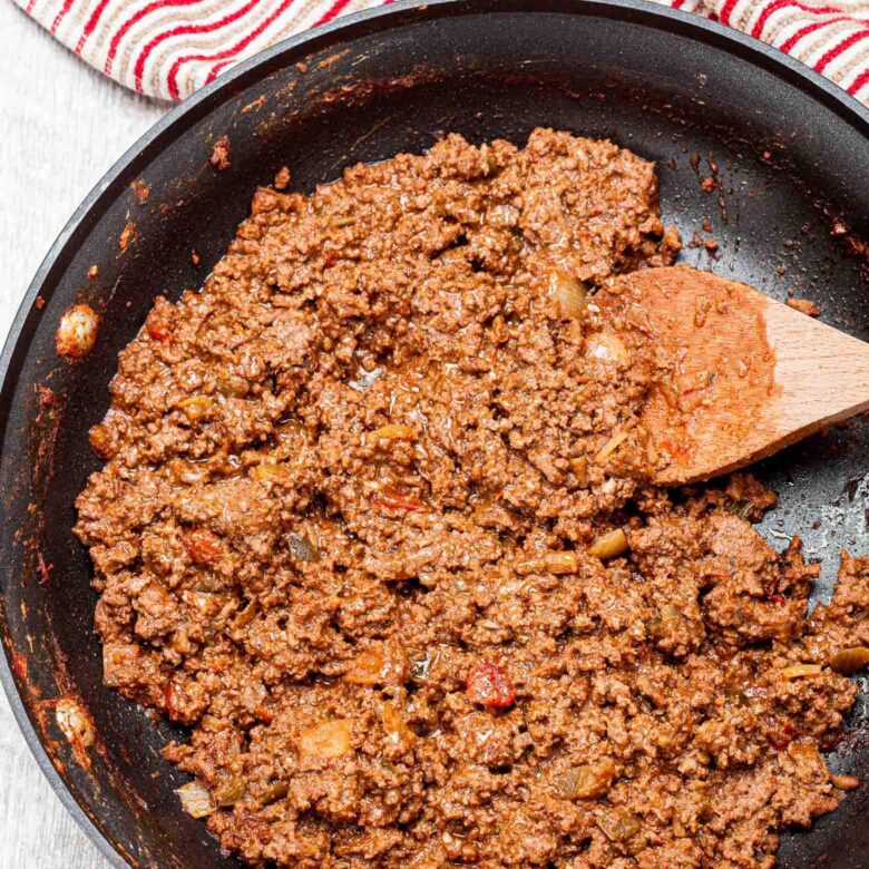 Ground beef mixture being cooked in a skillet.