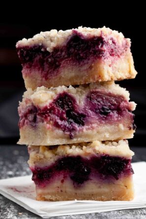 berry crumble bars stacked.