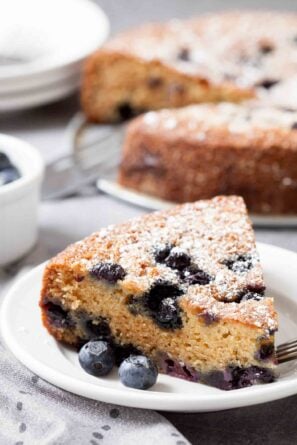 blueberry sour cream cake sliced and plated.