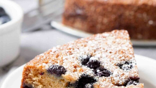 blueberry sour cream cake sliced and plated.