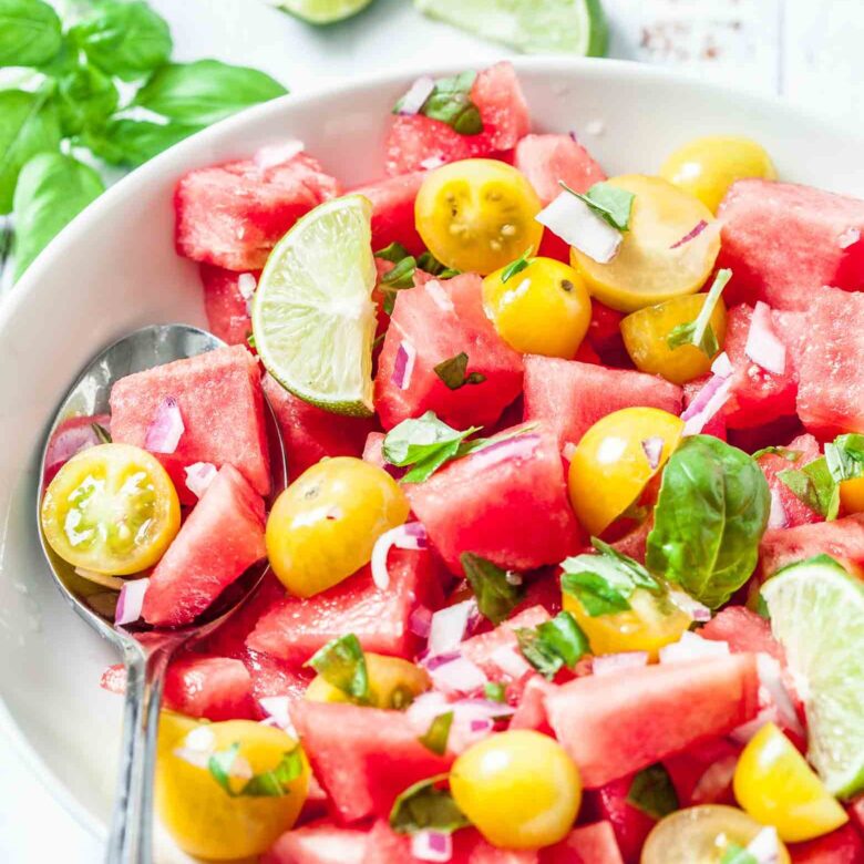 watermelon salad being mixed.