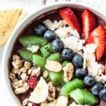 acai bowl with strawberries, blueberries, oats, kiwi, bananas.