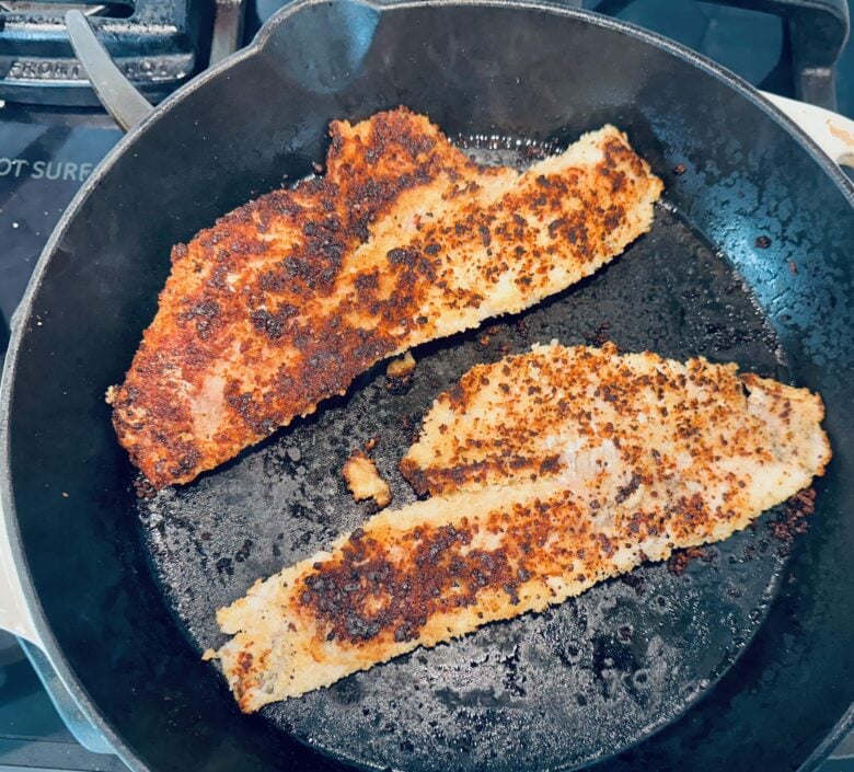 pan fried walleye cooking in pan.