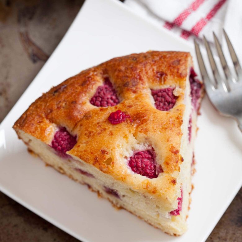 slice of easy raspberry cake on a plate.