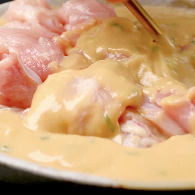 Chicken pieces being coated in mochiko chicken batter to make mochiko chicken recipe.