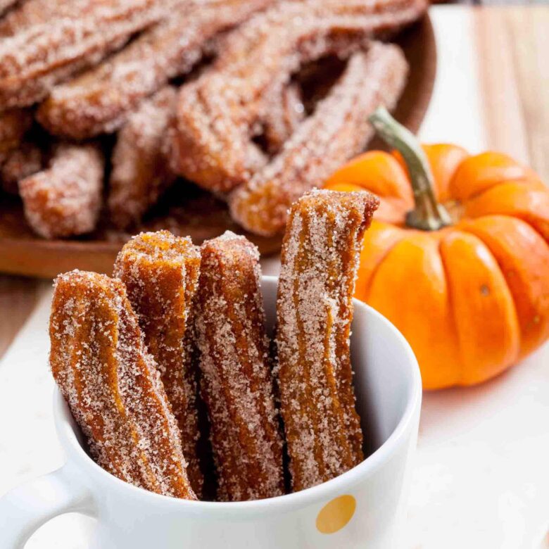 mini pumpkin churros in a mug.