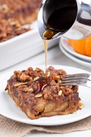 pumpkin French toast casserole with maple syrup poured on top.
