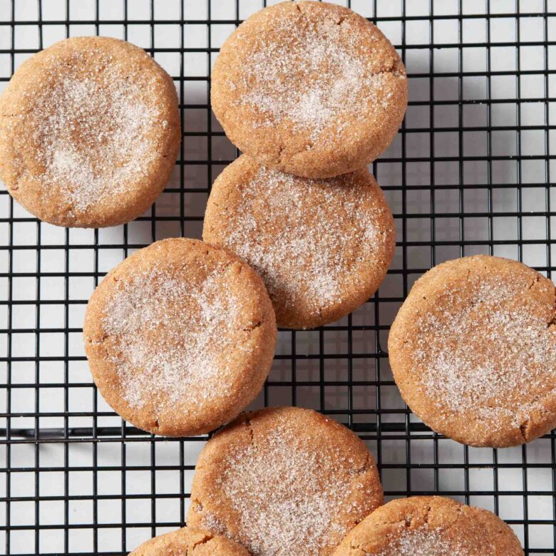 Overhead shot of cinnamon sugar-coated chewy pumpkin snickerdoodles on a cooling rack.