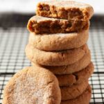 A stack of cinnamon sugar-coated chewy pumpkin snickerdoodles on a cooling rack.