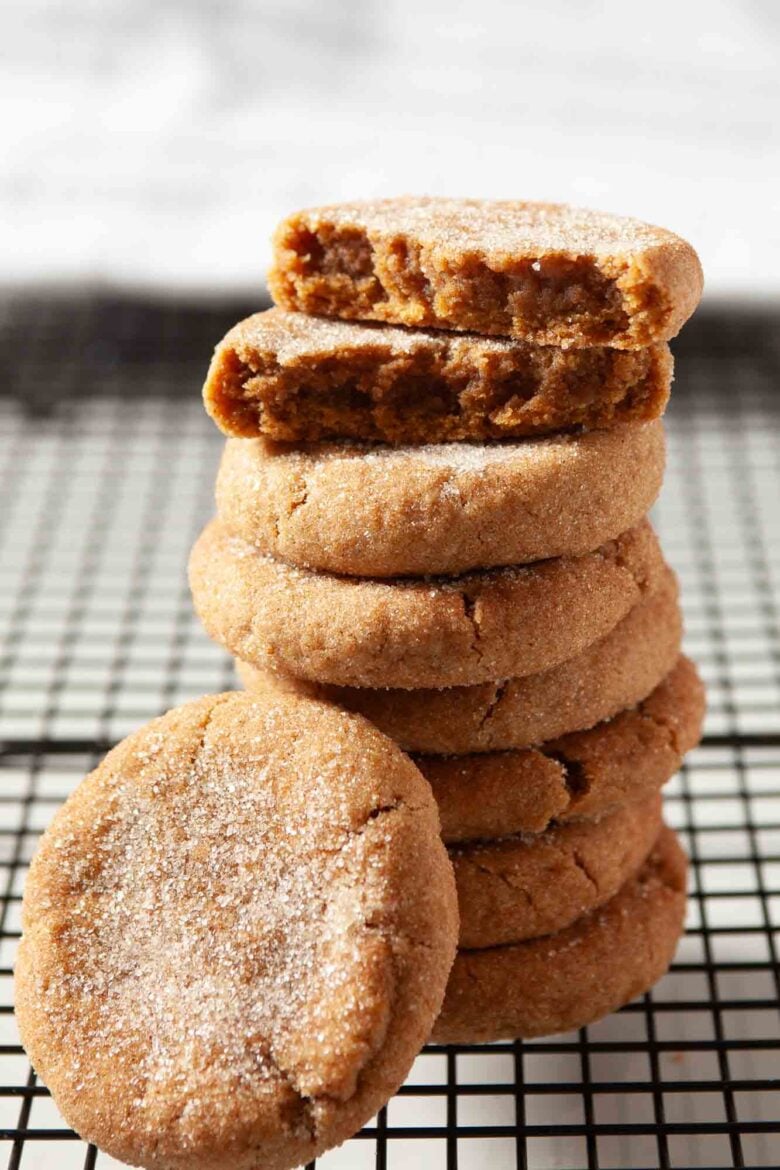 A stack of cinnamon sugar-coated chewy pumpkin snickerdoodles on a cooling rack.