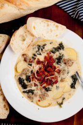 Overhead shot of homemade Zuppa Toscana soup, garnished with diced bacon and parmesan cheese.