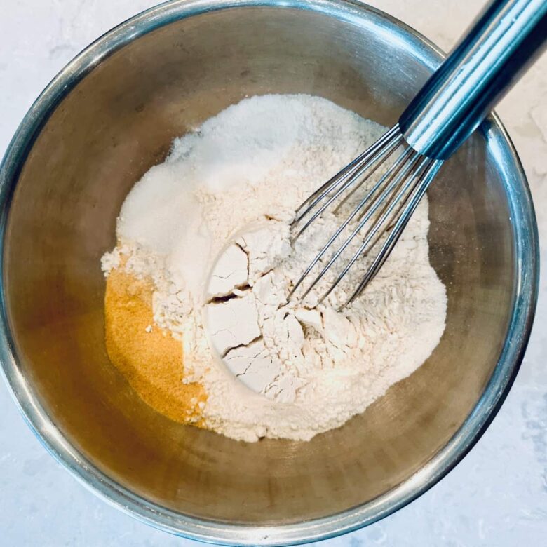 Dry ingredients to make cheddar bay biscuits being mixed in a bowl.