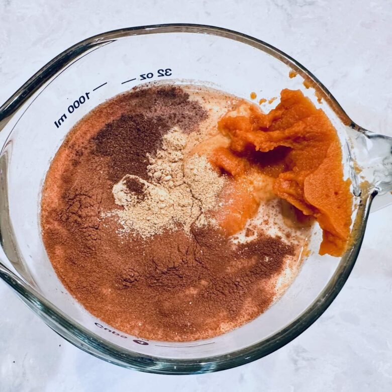 pumpkin pie filling ingredients in a measuring cup. 