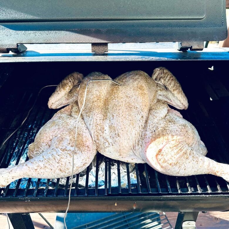 smoked spatchcock turkey set in smoker.