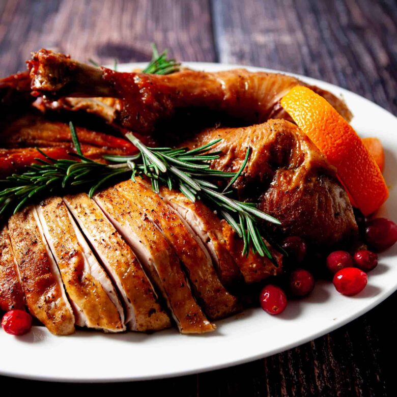 smoked spatchcock turkey plated and garnished.
