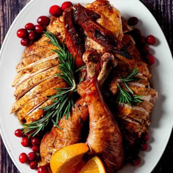 smoked spatchcock turkey sliced and plated.