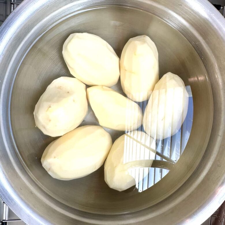 Peeled potatoes inside an instant pot.