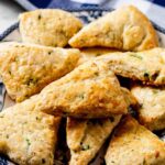 savory scones stacked on a plate.
