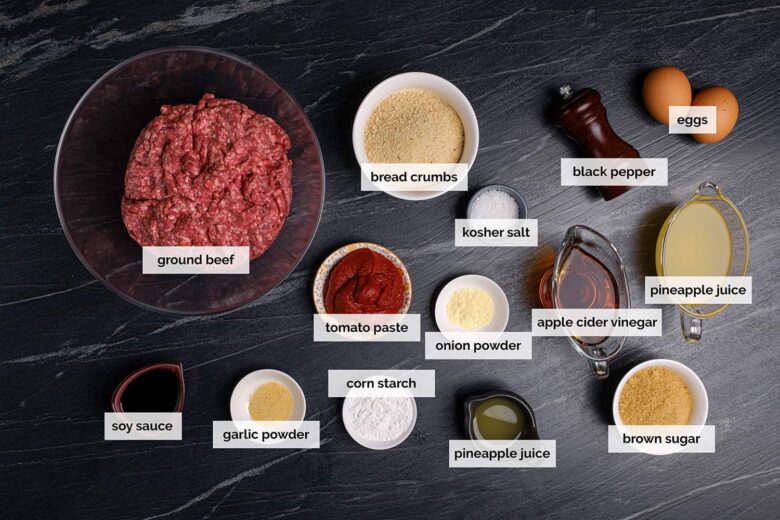 Overhead shot of ingredients to make sweet and sour meatballs on a dark surface.