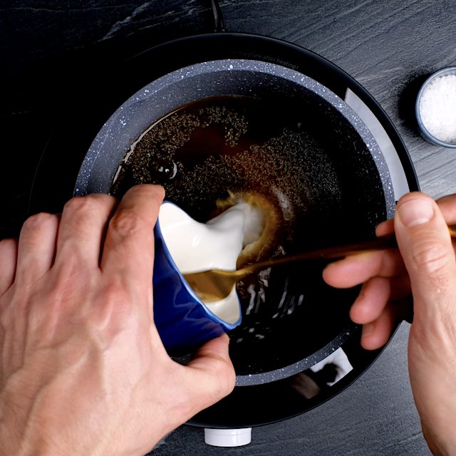 Cornstarch slurry being added to sweet and sour sauce mixture to make sweet and sour meatballs.