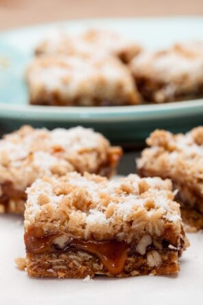 Closeup shot of caramelita bar with ooey gooey caramel, topped with finely shredded coconut.