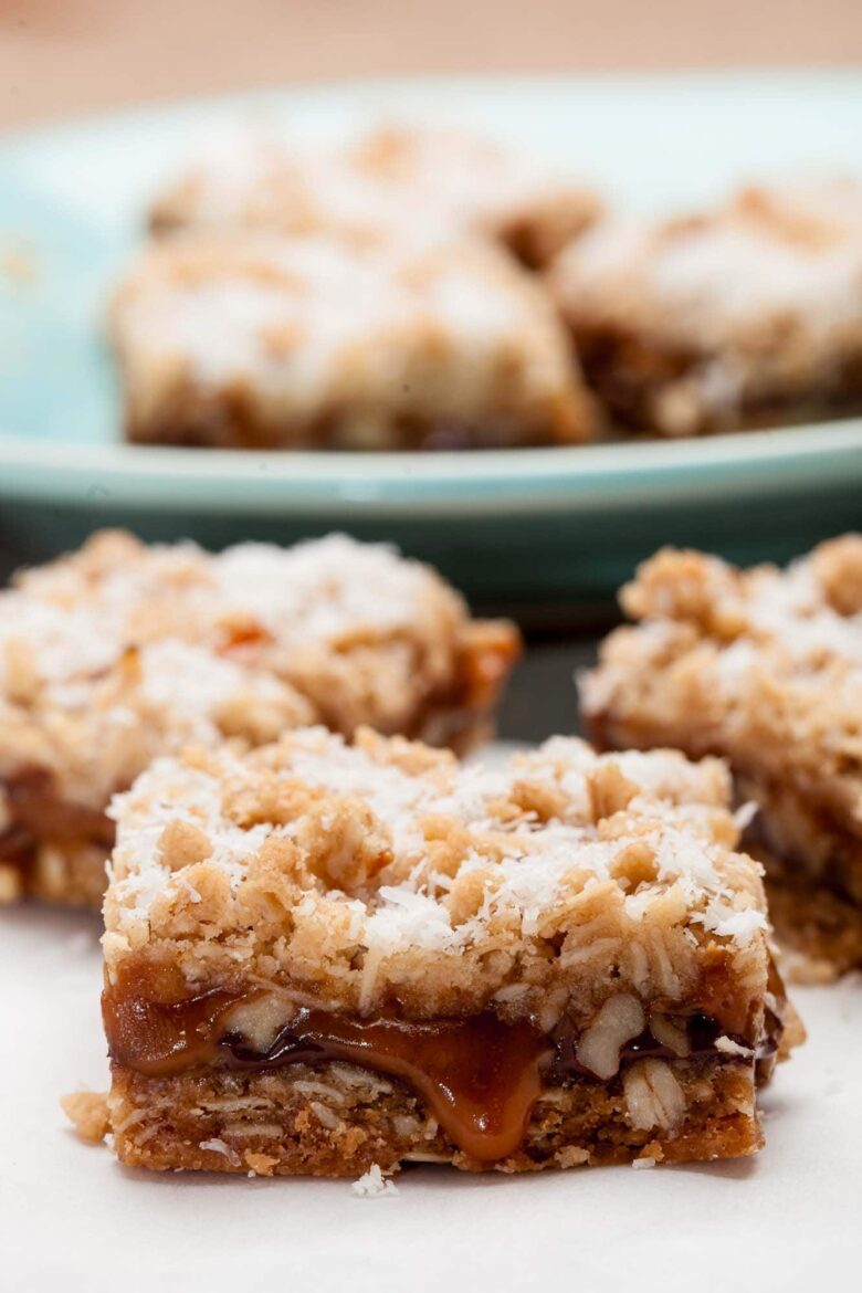 Closeup shot of caramelita bar with ooey gooey caramel, topped with finely shredded coconut.