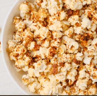 Tossing kettle corn in a bowl after it's done.