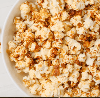Tossing kettle corn in a bowl after it's done.