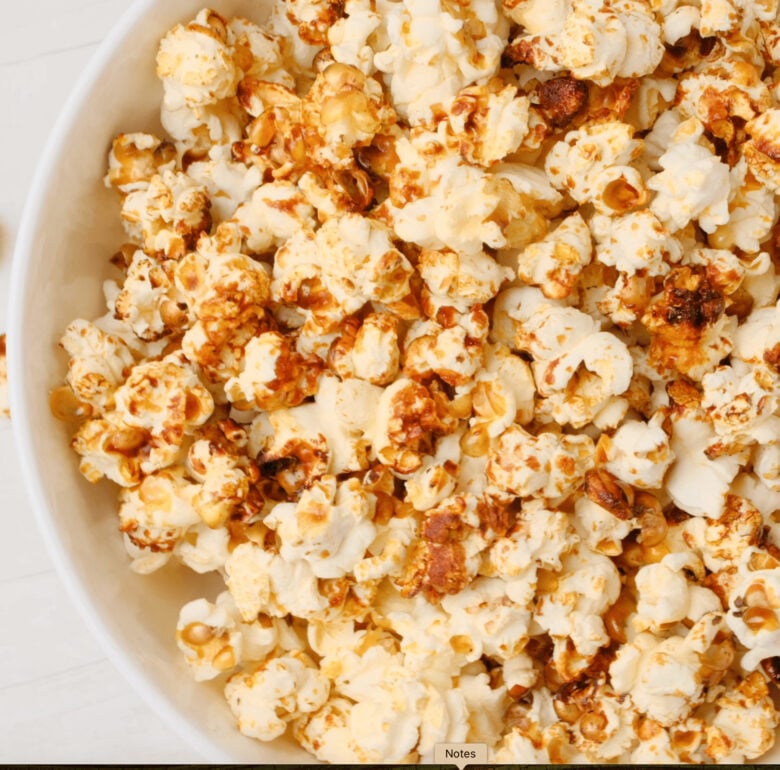 Tossing kettle corn in a bowl after it's done.