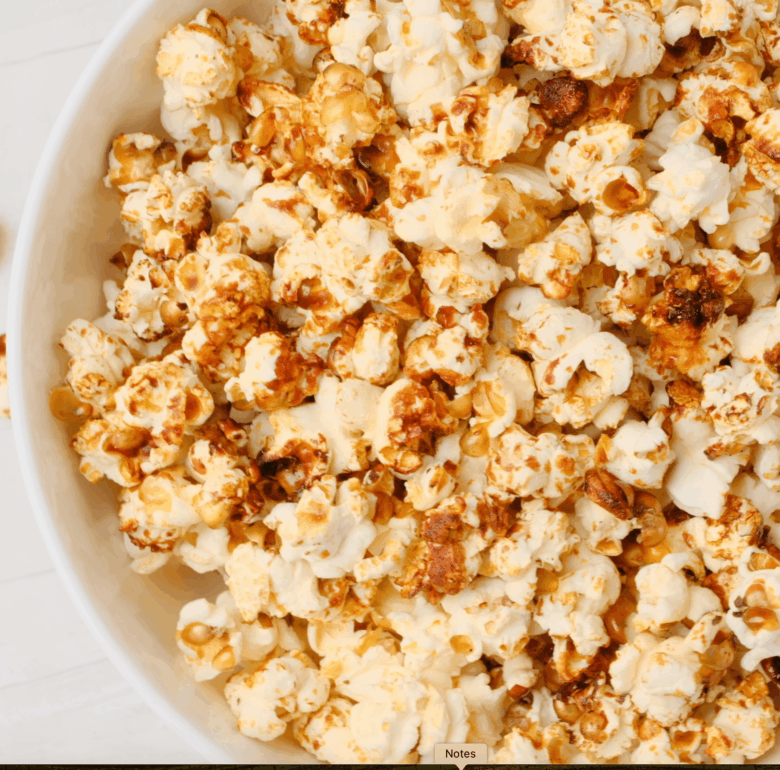 Tossing kettle corn in a bowl after it's done. 