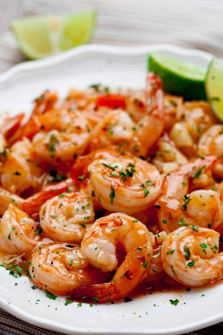 Closeup shot of Honey Lime Shrimp garnished with herbs.