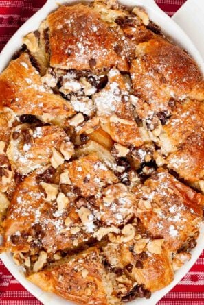 Overhead shot of a freshly baked Nutella bread pudding with chopped nuts.