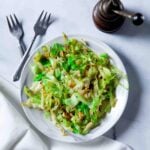 Overhead shot of a white bowl of freshly made sautéed cabbage.