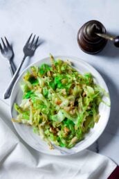 Overhead shot of a white bowl of freshly made sautéed cabbage.