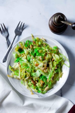 Overhead shot of a white bowl of freshly made sautéed cabbage.