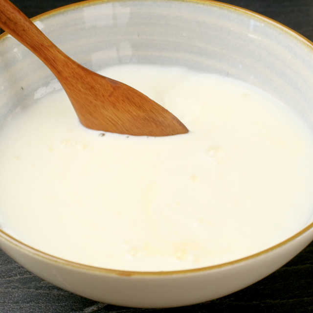 Lemon juice being stirred into milk to make banana cake with cream cheese frosting at home.