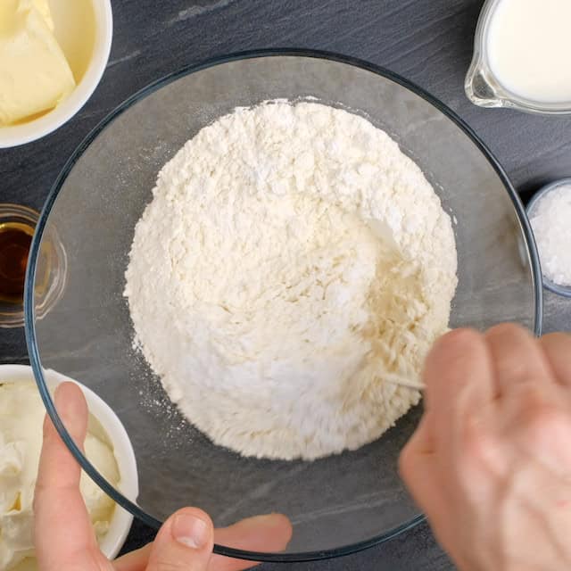 Dry ingredients to make banana cake with cream cheese frosting being whisked together.
