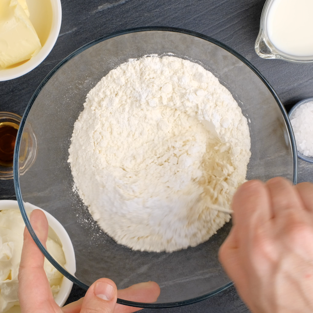 Dry ingredients to make banana cake with cream cheese frosting being whisked together.