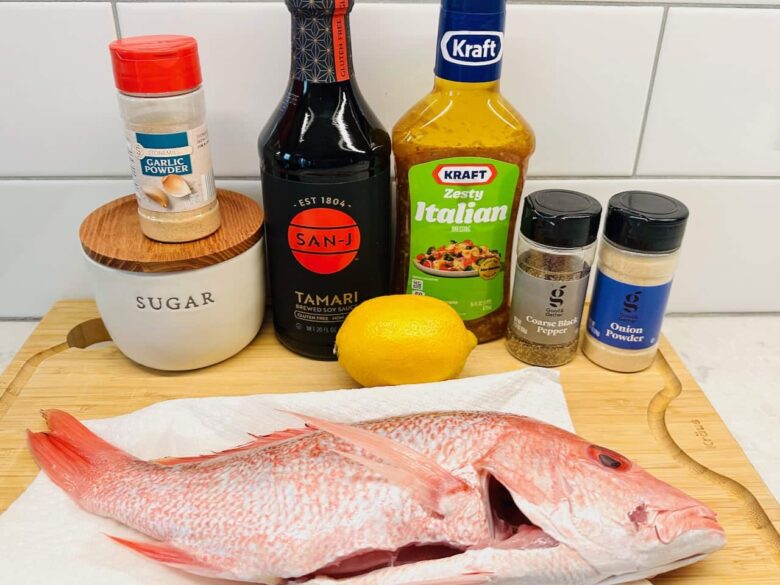 Ingredients to make grilled red snapper on a kitchen counter.