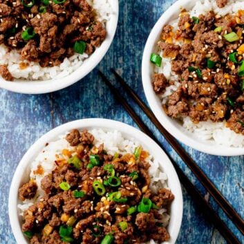 Overhead shot of Korean beef bowls garnished with sliced green onions.