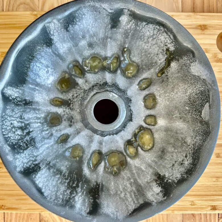 Overhead shot of a greased bundt cake to make poppy seed cake at home.