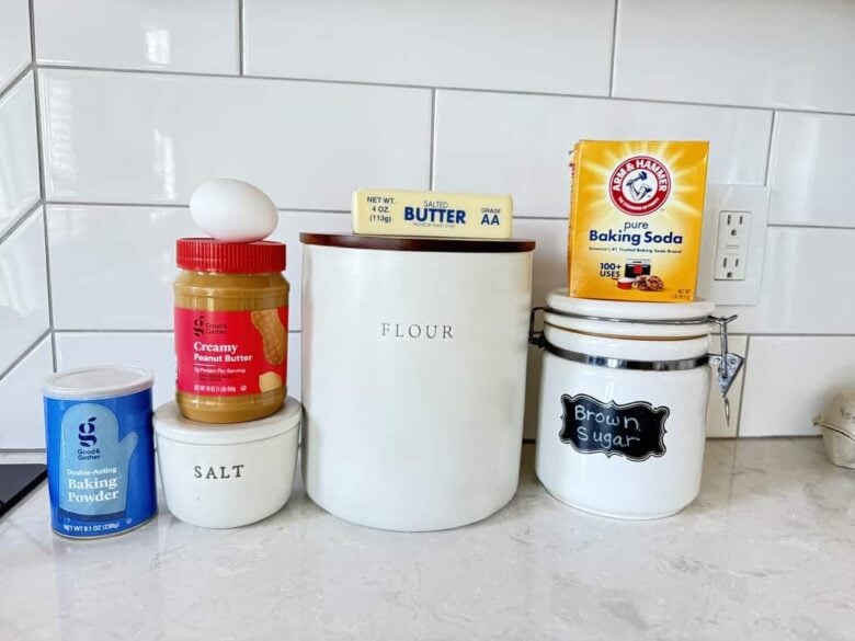 chewy peanut butter cookie ingredients like flour, butter, brown sugar, baking powder, baking soda, and creamy peanut butter. 