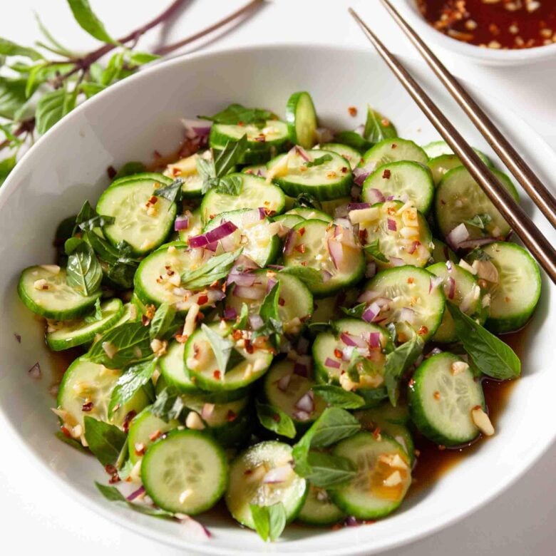 Closeup shot of Asian cucumber salad with crisp sliced cucumbers and tangy dressing.