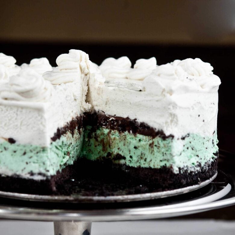 Mint chocolate chip ice cream cake with whipped cream on top.