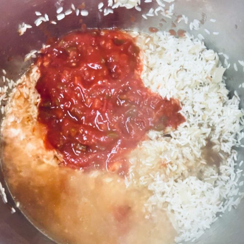 Chunky salsa added to instant pot with rice to make instant pot mexican rice.