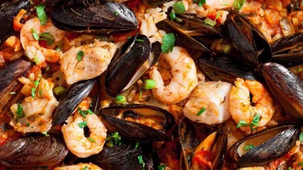 Overhead shot of easy seafood paella with fish, shrimp, and shell fish.