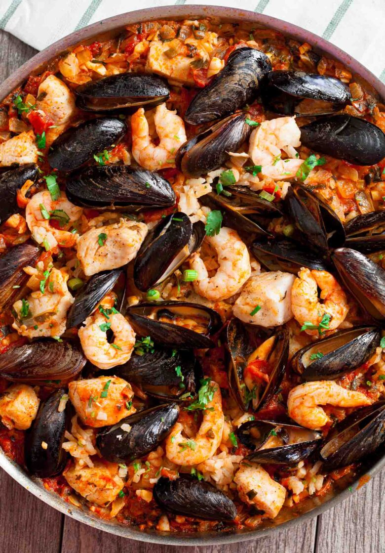 Overhead shot of easy seafood paella with fish, shrimp, and shell fish.