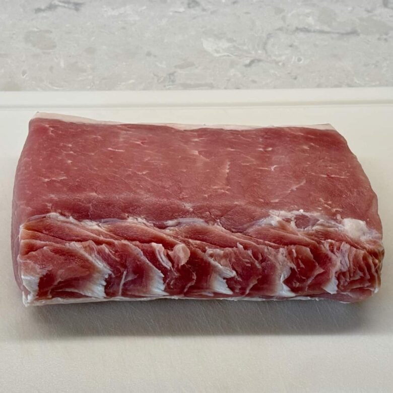 Pork loin with excess fat trimmed off to make smoked pork loin.