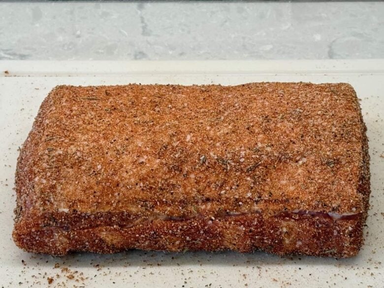 Dry rub pressed onto pork loin from all sides.