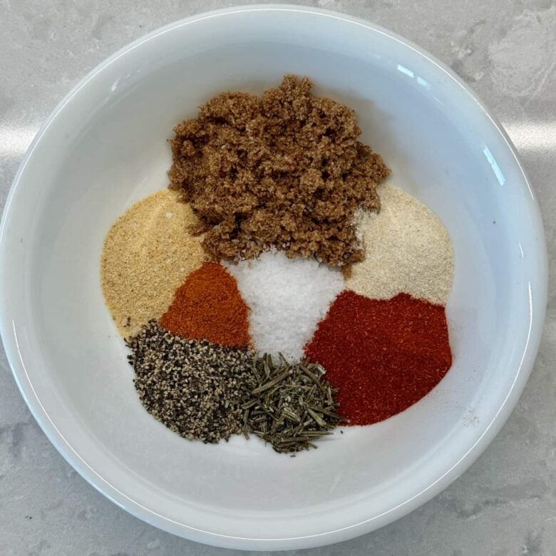 Smoked pork loin dry rub seasonings in a bowl, ready to be combined.